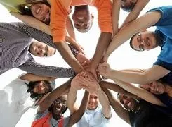 Diverse hands joined in a team huddle